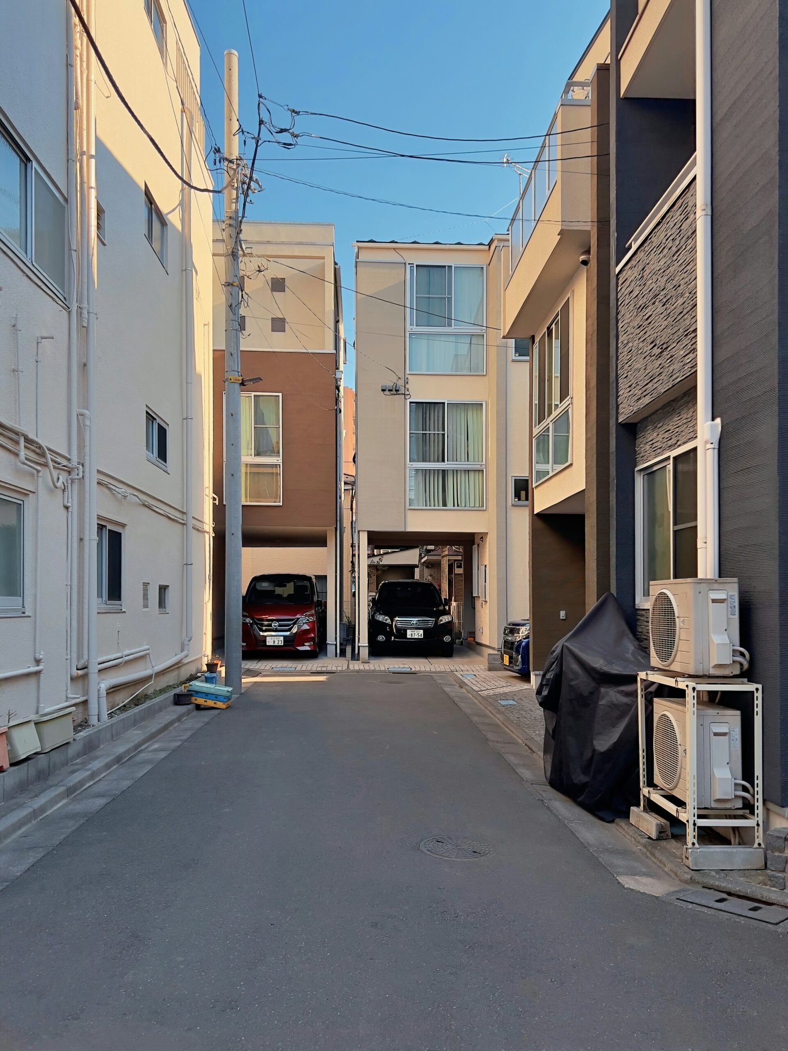 an empty street with a car parked on the side of it